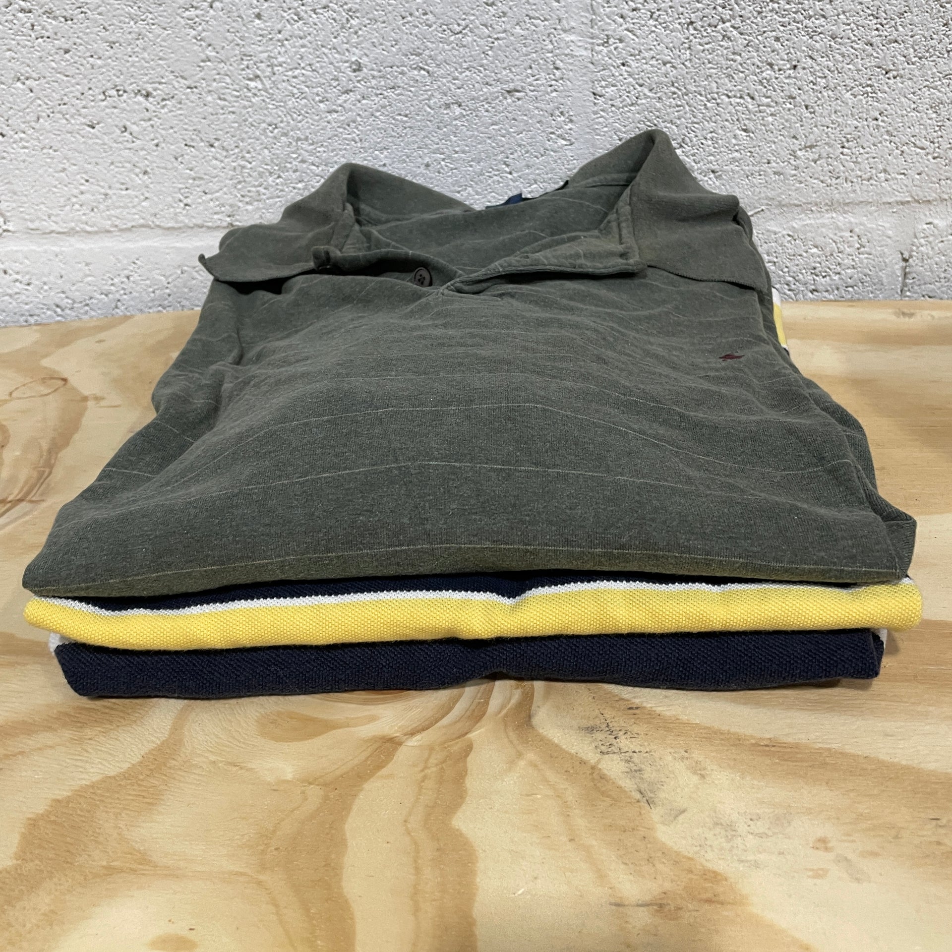 Brand Name Polo Shirts on table